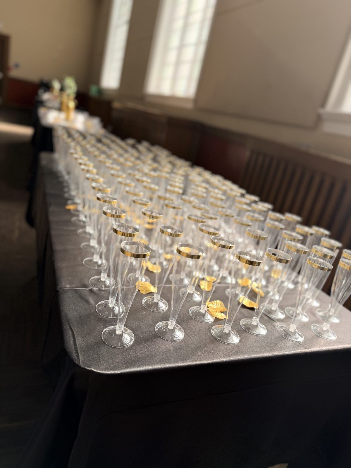 A long table of filled champagne flutes ready for a toast